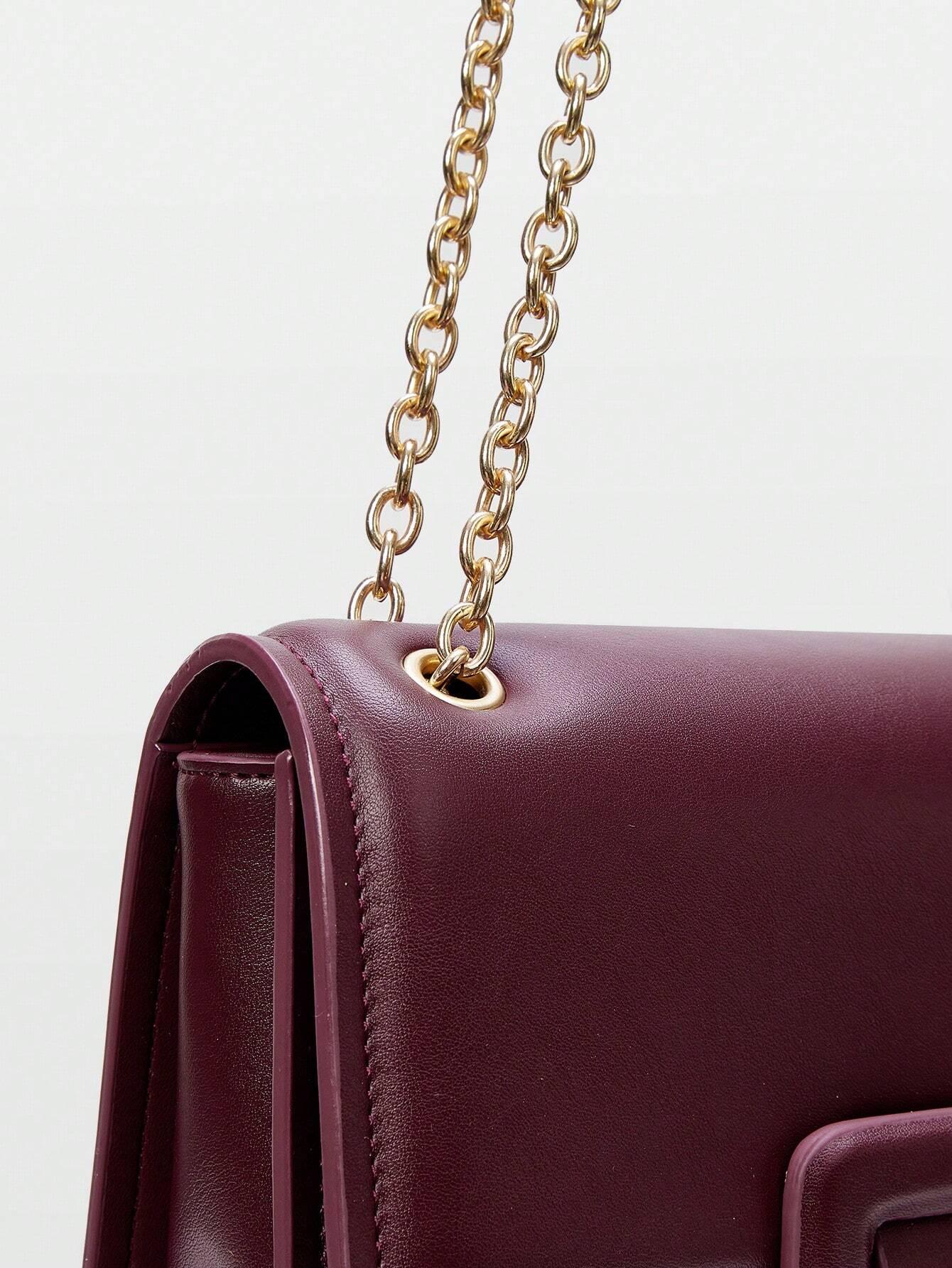 Borsa a tracolla con catena e fibbia “Stella”